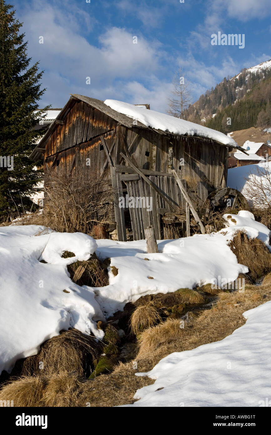 Old wooden watermill in Village of Colfosco at night in winter snow ,Dolomites , Italy. Stock Photo