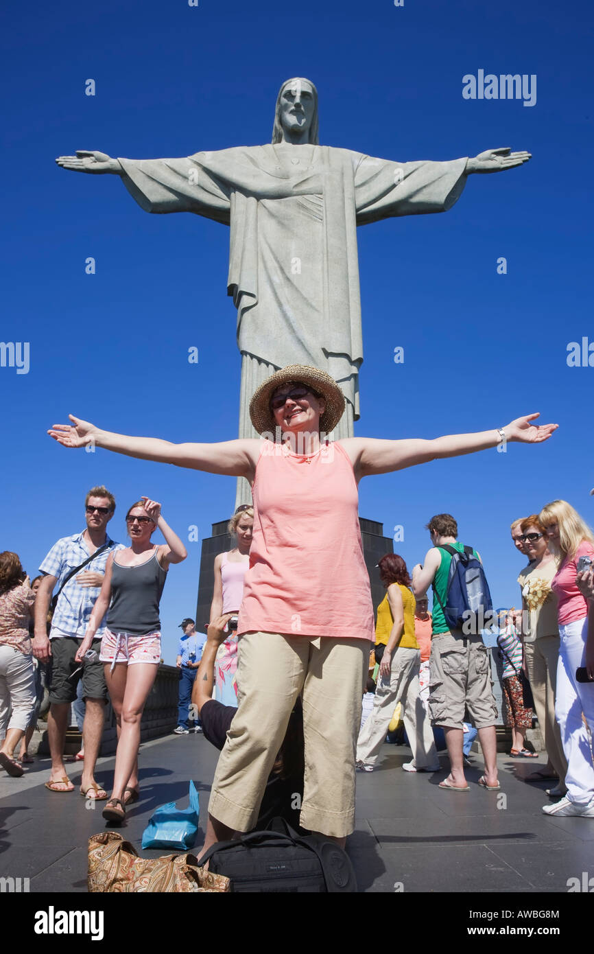 Tourist posing in front of the Christ the Redeemer on Corcovado Mountain Rio de Janeiro Brazil South America Stock Photo