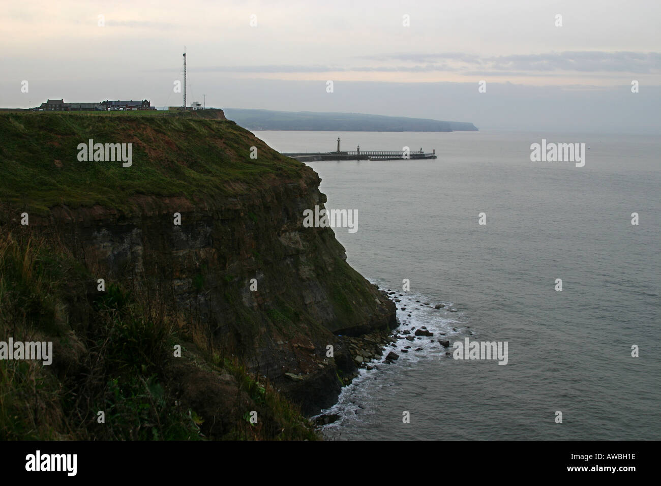 South headland with coastguard station and piers in background at Whitby in North Yorkshire