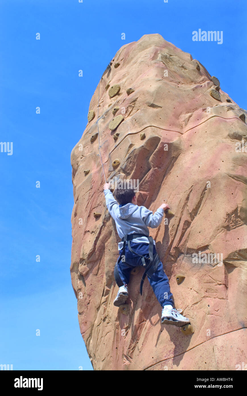 Rear view of a small boy rock climbing Stock Photo