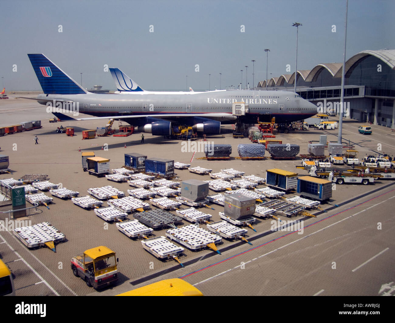 A commercial airplane docked at Hong Kong's Chek Lap Kok International Airport at  is ready for loading baggage & supplies Stock Photo