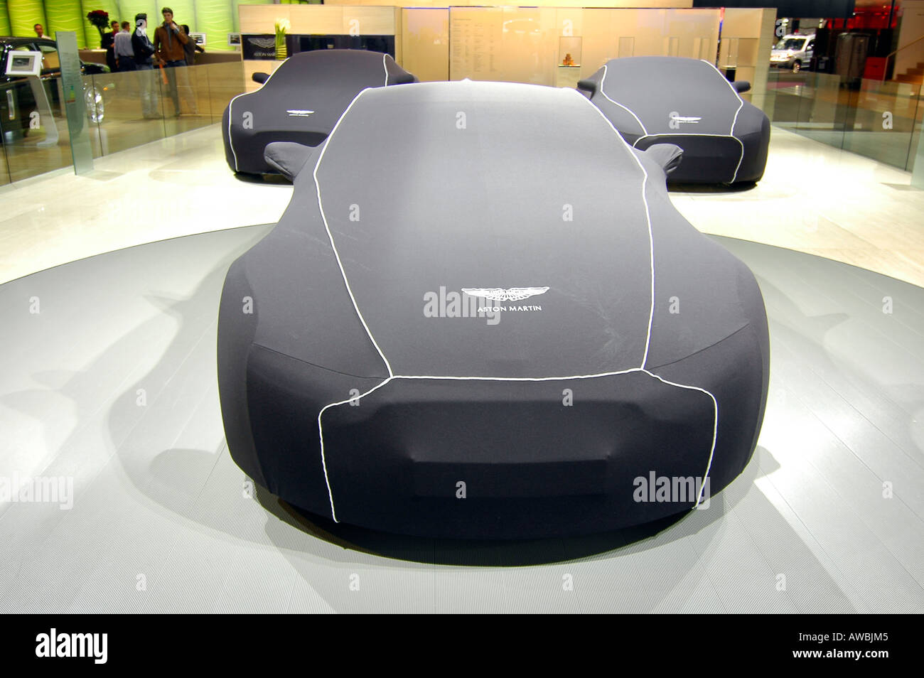 Aston Martin sport cars protected under their housing cover during the Paris World Car Show Stock Photo