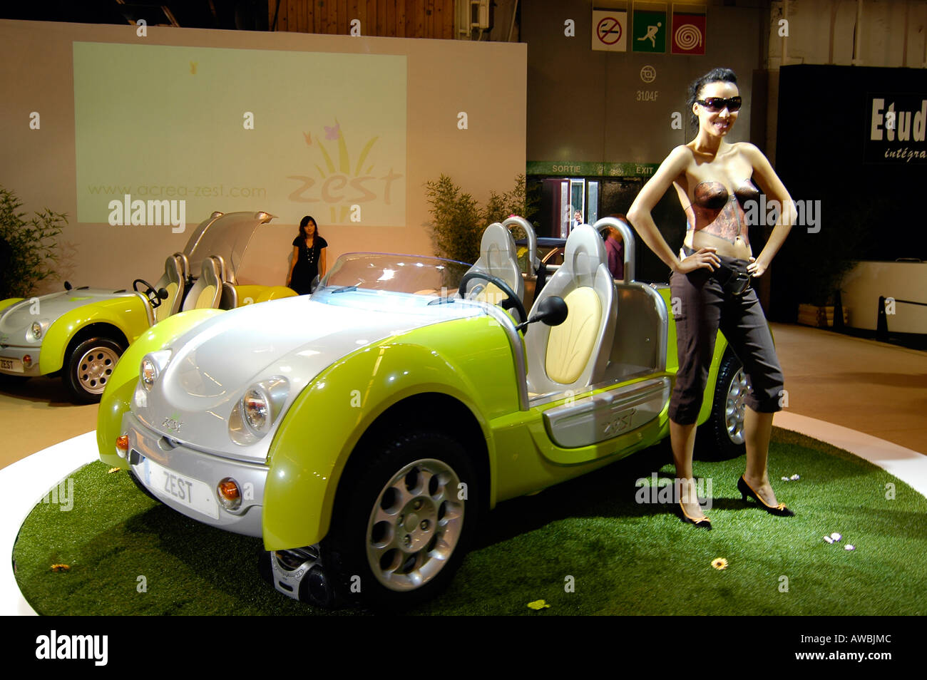 A sexy hostess posing a car exhibited at the Paris International Auto Show  Stock Photo - Alamy