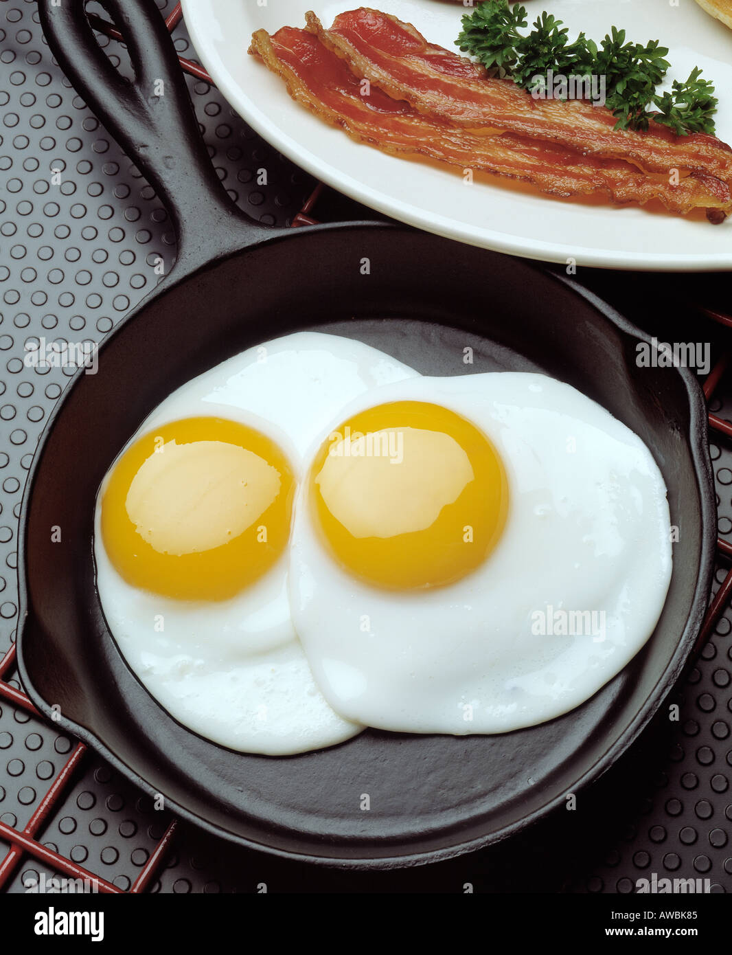 breakfast two fried eggs black cast iron fry pan sunny side up two