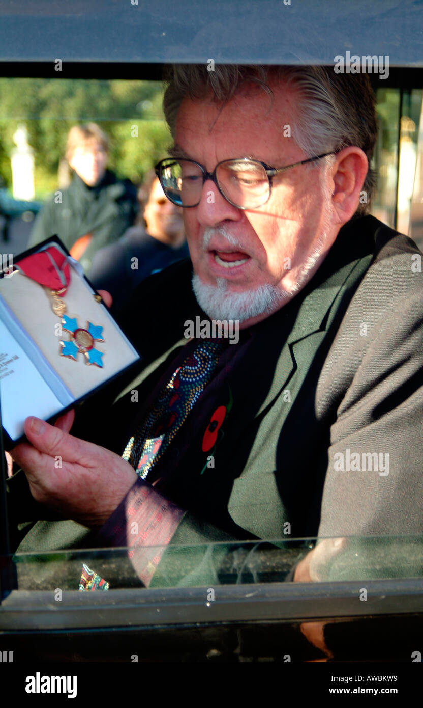 Performer and artist Rolf Harris with his CBE after the investiture at Buckingham Palace London Stock Photo