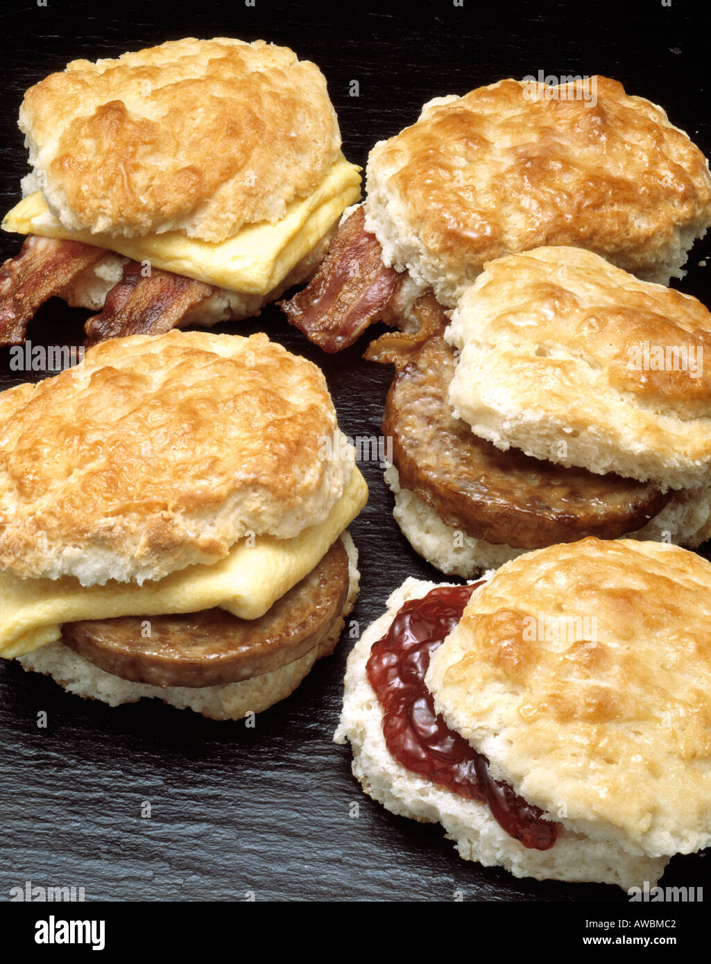 hearty breakfast two fried eggs scrambled english muffin sandwiches sausage meat patty bacon Bon