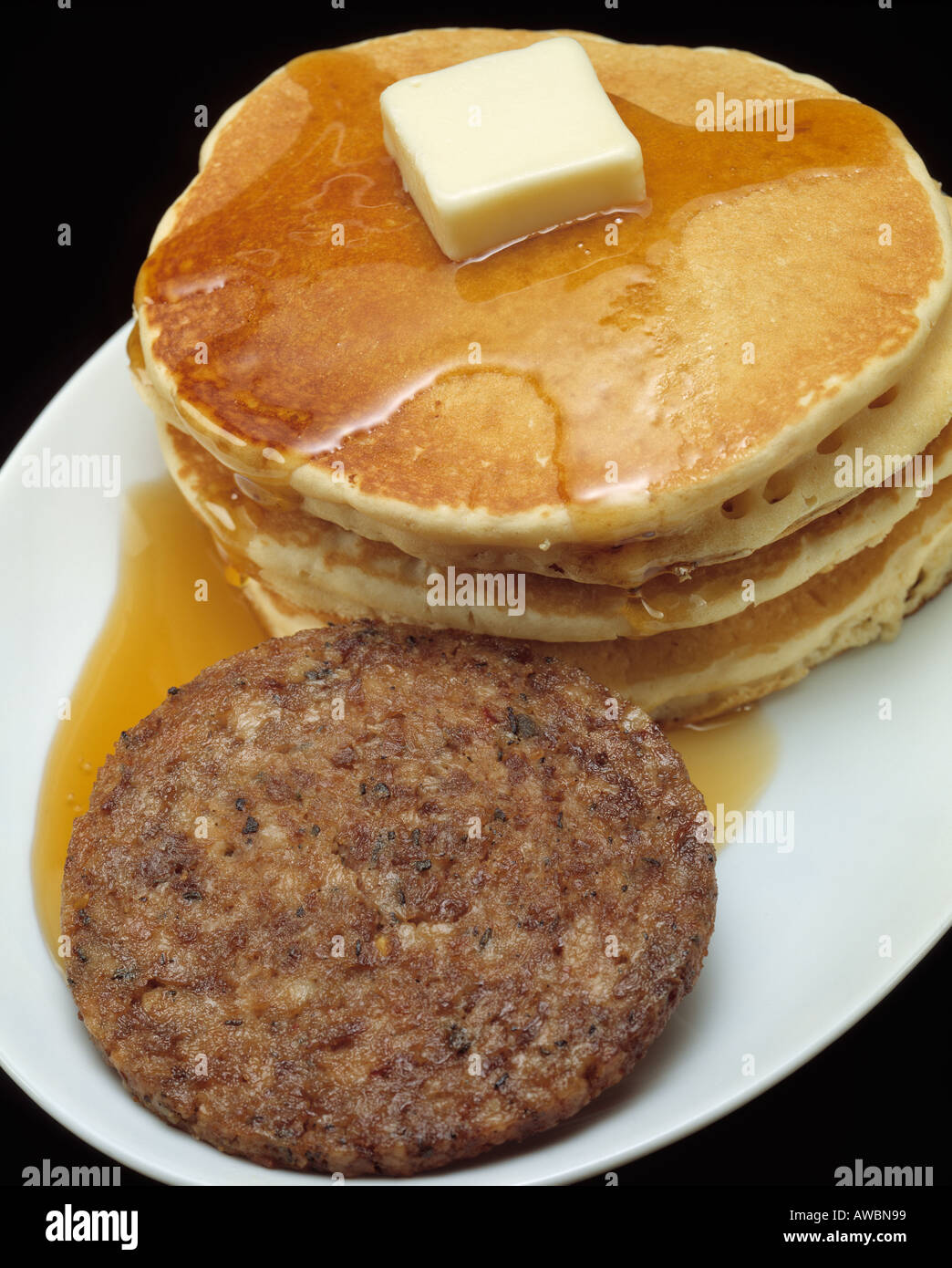 fast food hearty breakfast stack of pancakes sausage patty melted