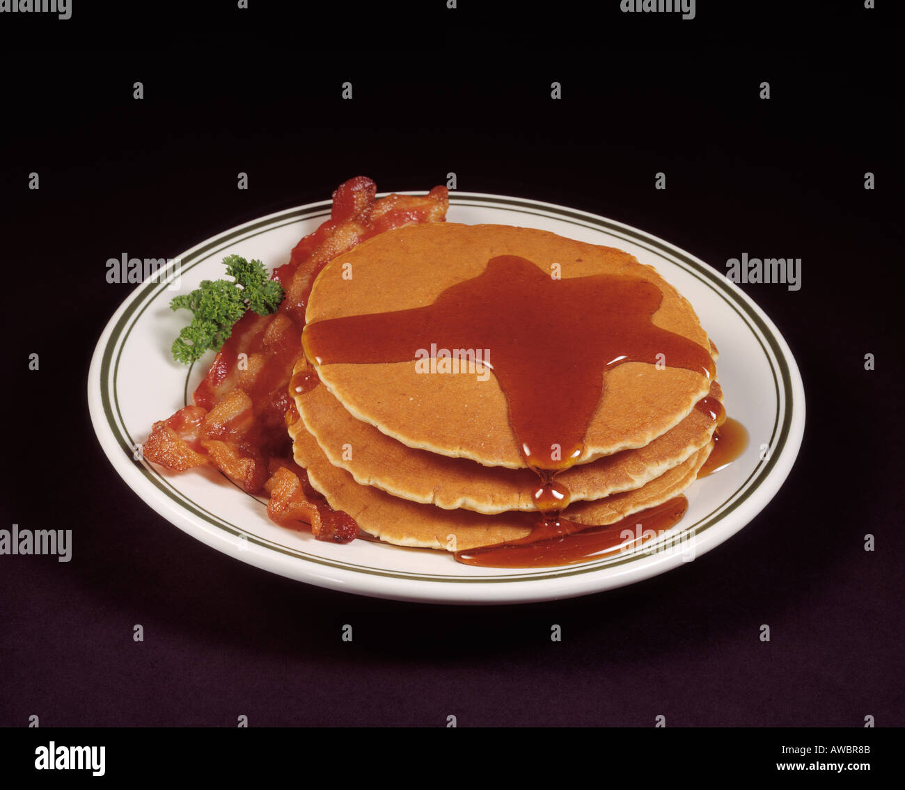 fast food hearty breakfast stack of pancakes bacon strips slices Stock