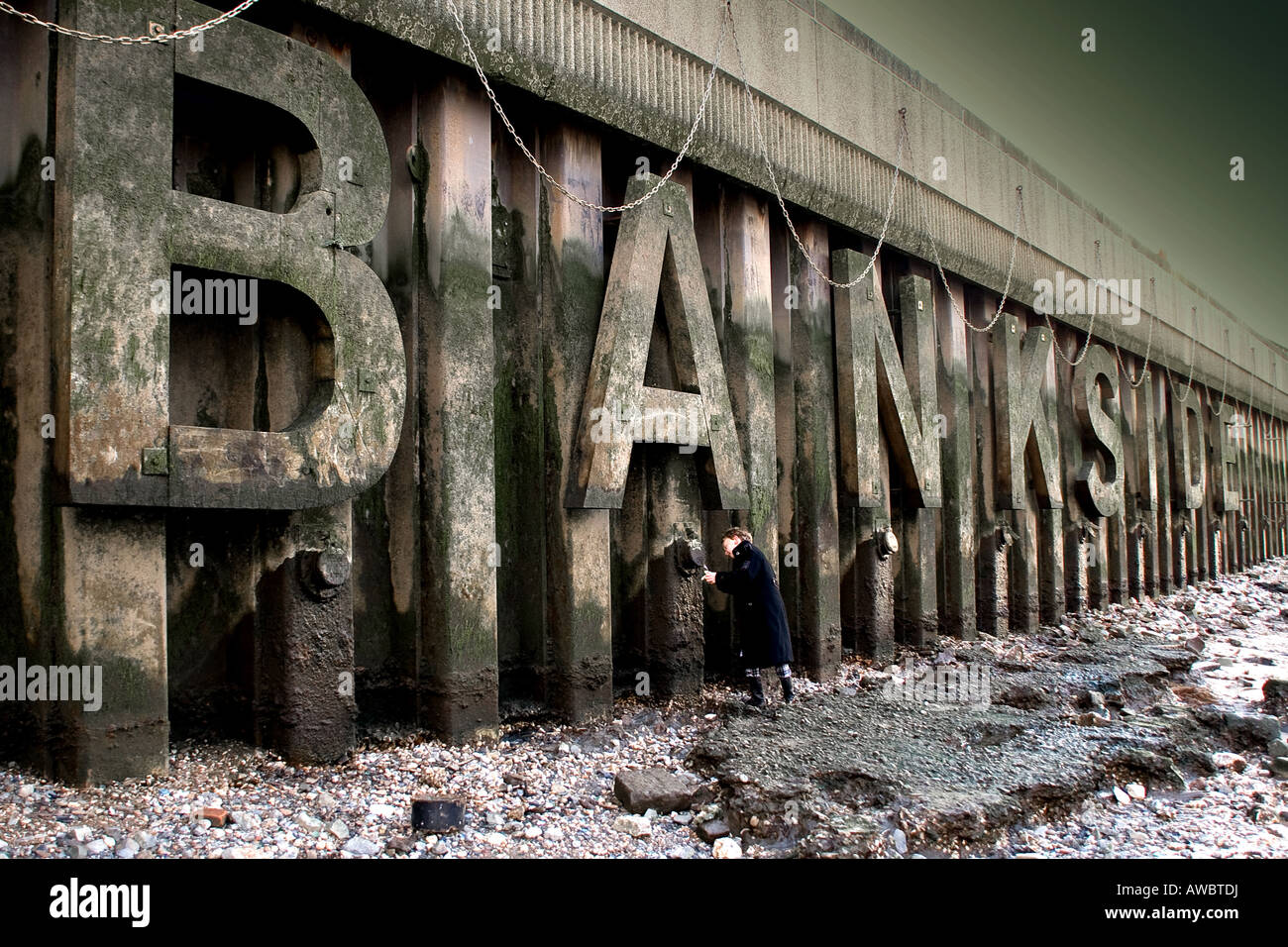 young boy (9 years old) playing on thames foreshore, bankside, south bank, london uk Stock Photo