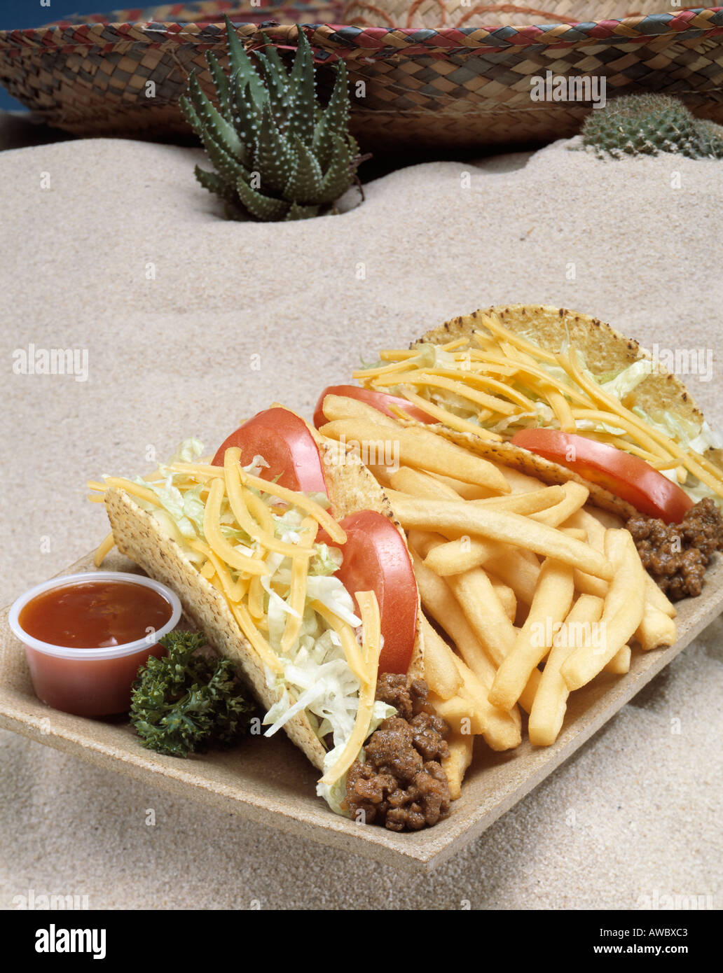 two hard shell tacos meat hamburger cheese lettuce salsa tomato tomatoe