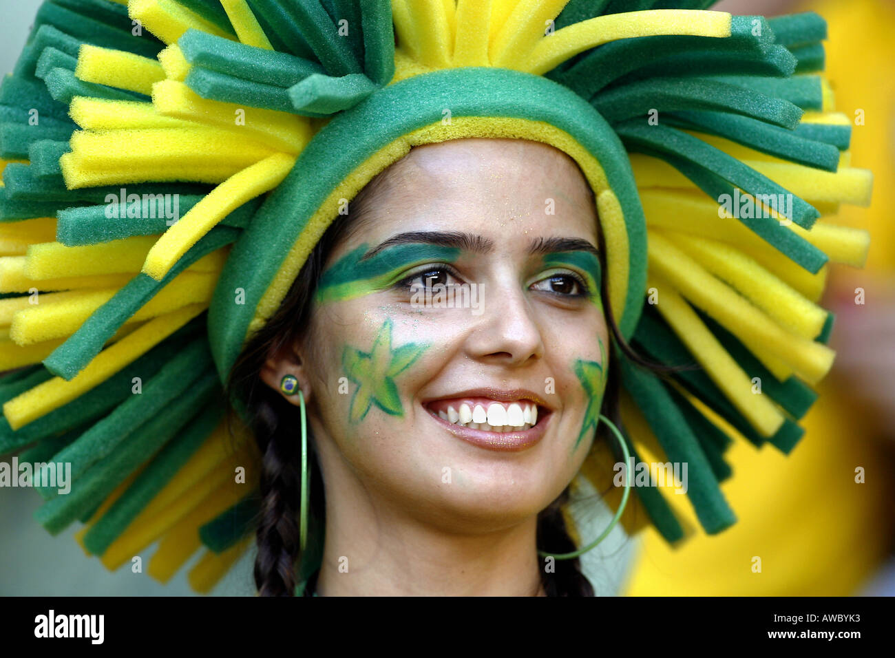 A pretty Brazilian woman with a painted face and wearing a wig during the 2006 World Cup Stock Photo