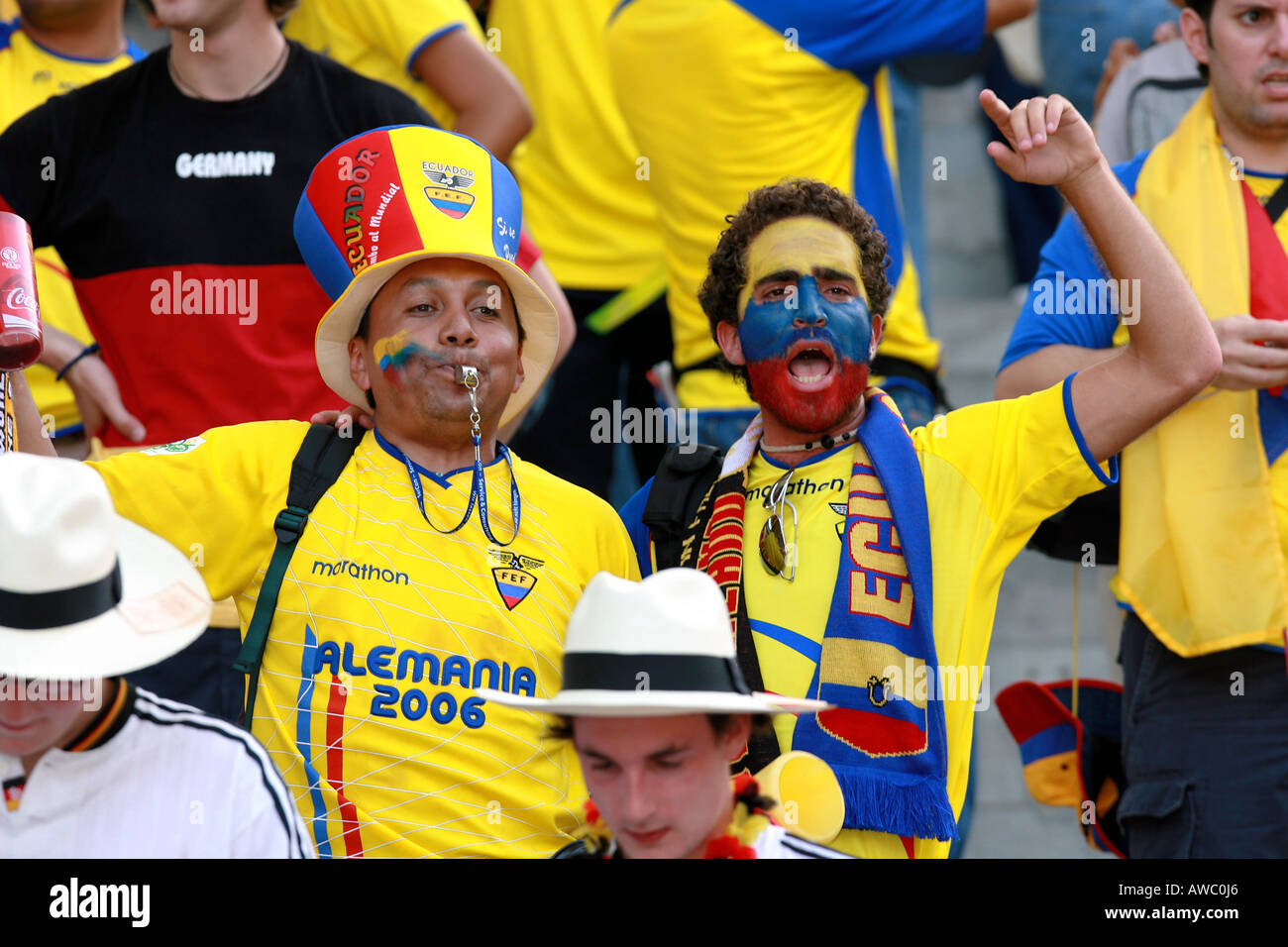 Two Ecuadorian fans with painted faces sing in the crowd during the 2006 World Cup Stock Photo