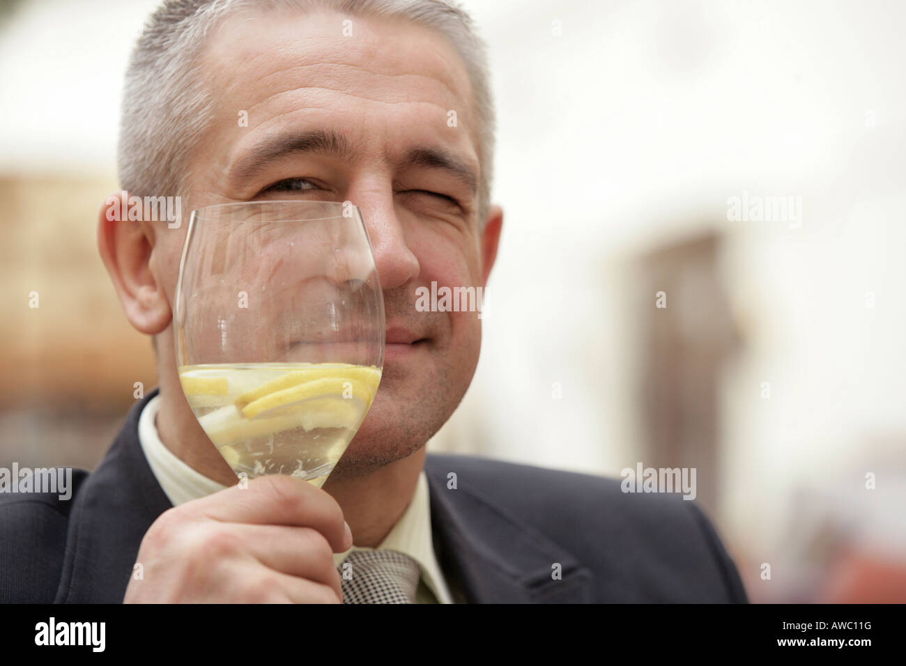 Smiling businessman with glass of mineral water Stock Photo Alamy