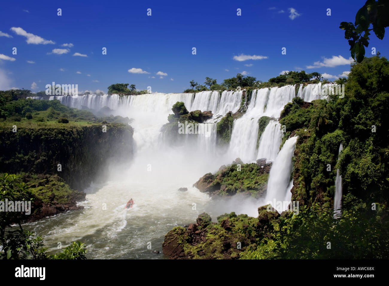 Iguassu Falls is the largest series of waterfalls on the planet This image shows one of the river tour boats Stock Photo