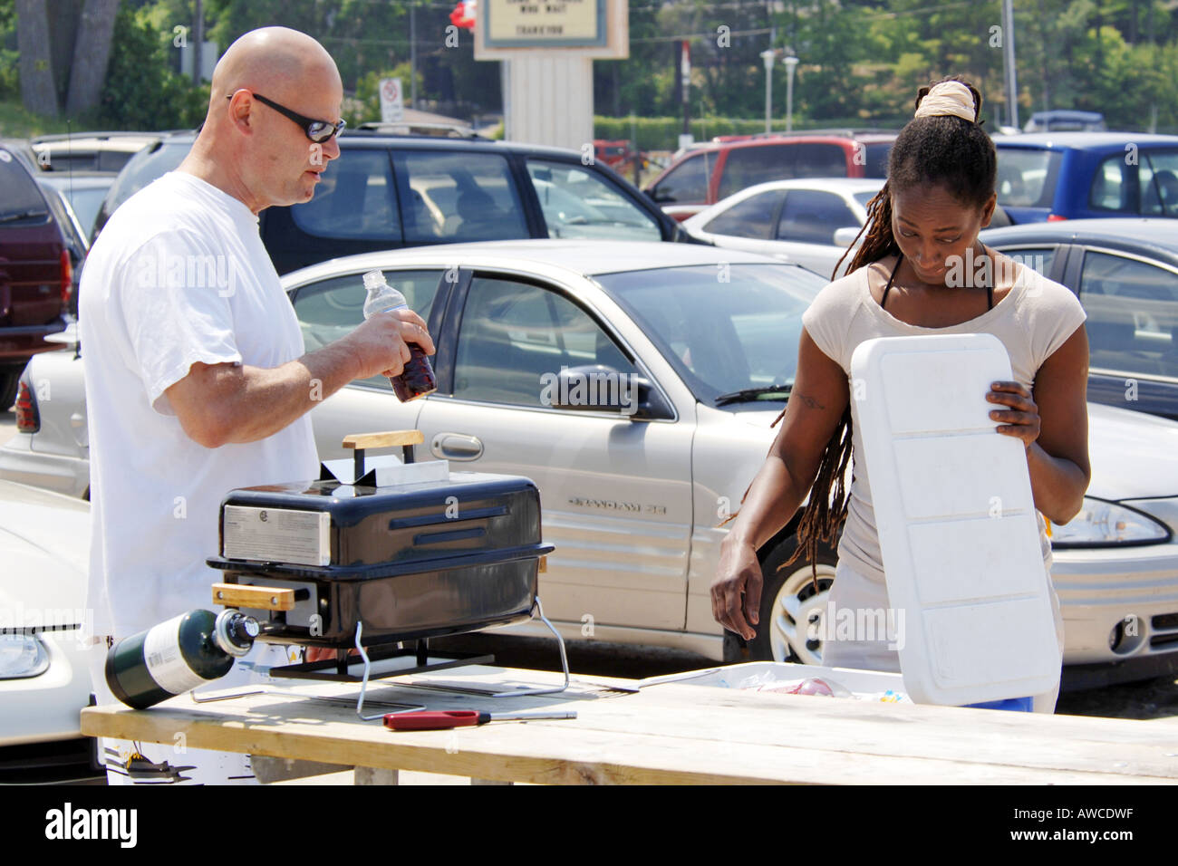 A multi-racial relationship couple making a beach bbq lunch Stock Photo