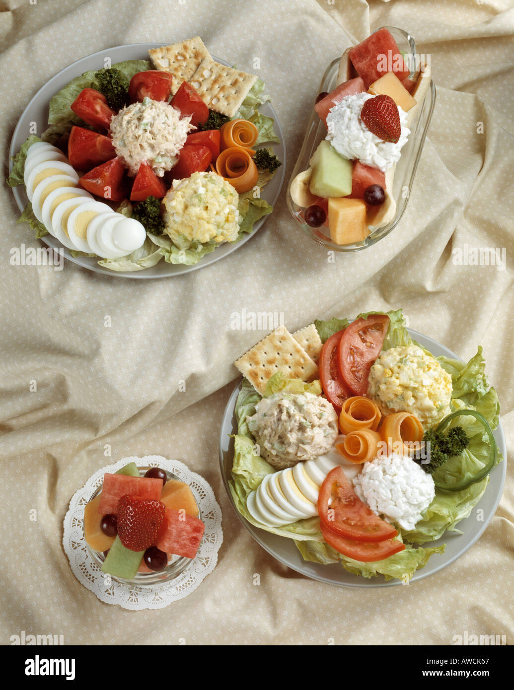 assorted assortment salad plates fruit hard boiled eggs tomato tomatoe