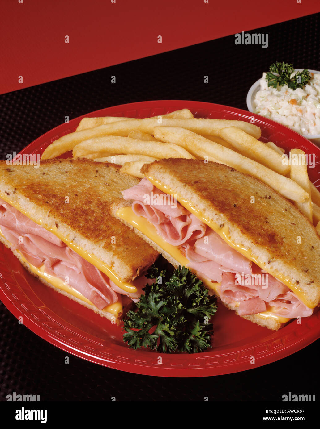 toasted ham and cheese sandwich red plate french fry fries cole slaw copy space Bon Appetit