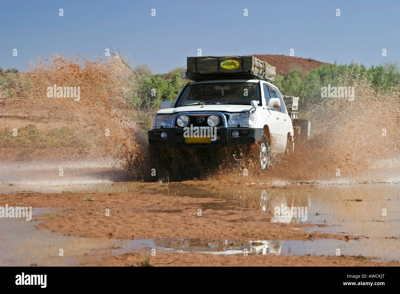 Off-road vehicle is crossing a river, Namibia, Africa Stock Photo