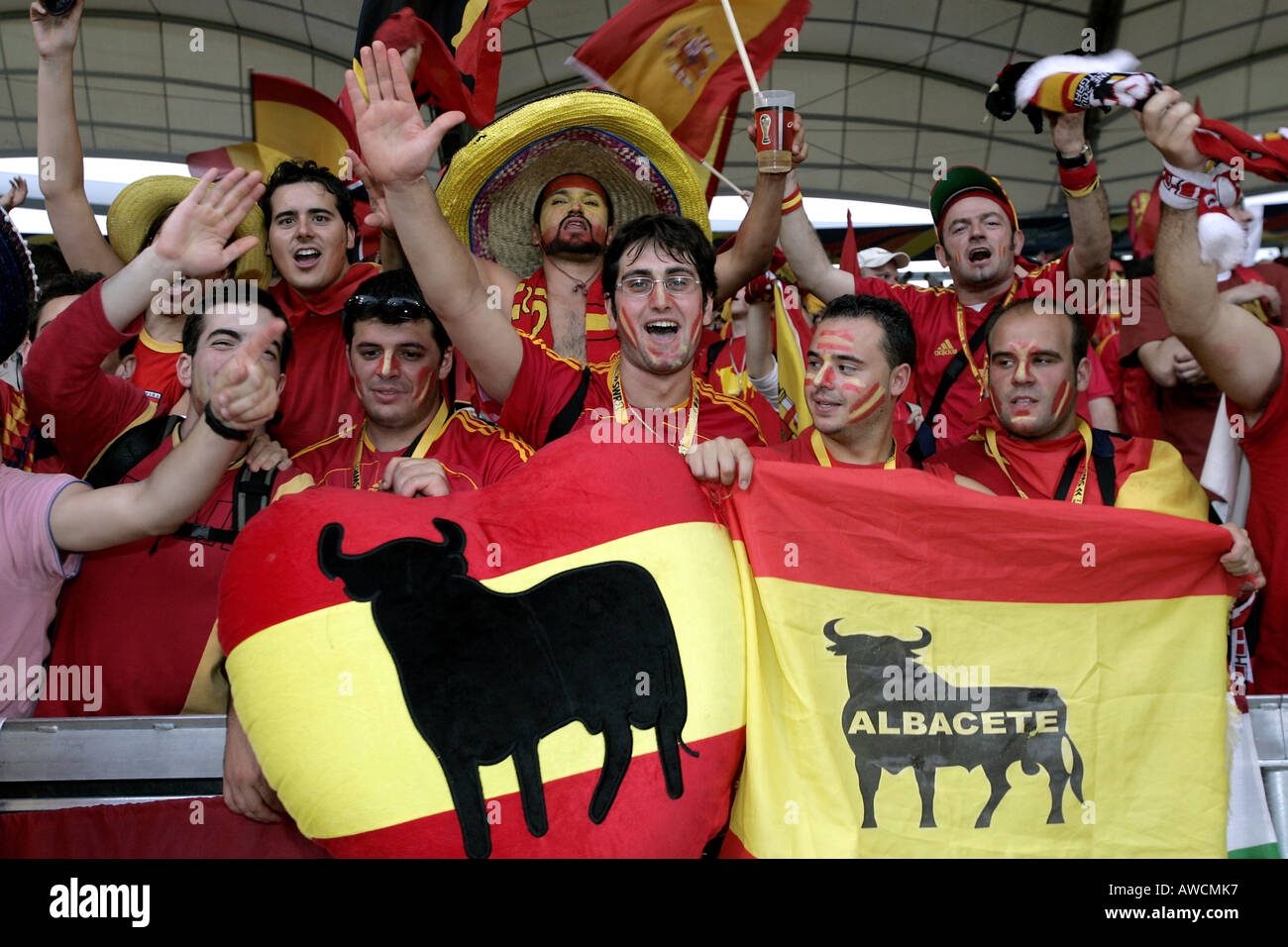 Spanish fans holding flags sing in the crowd during the 2006 World Cup