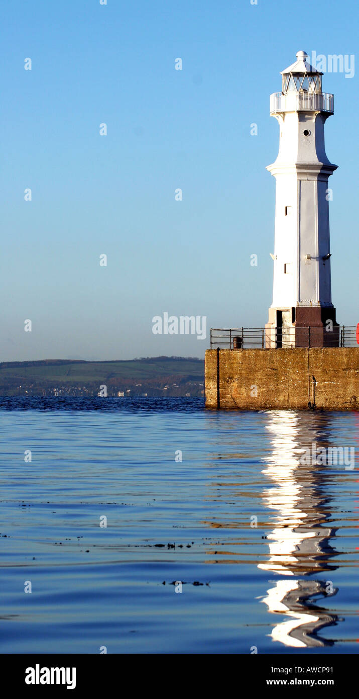 Old White cast-iron Lighthouse on harbour wall on a bright sunny day ...