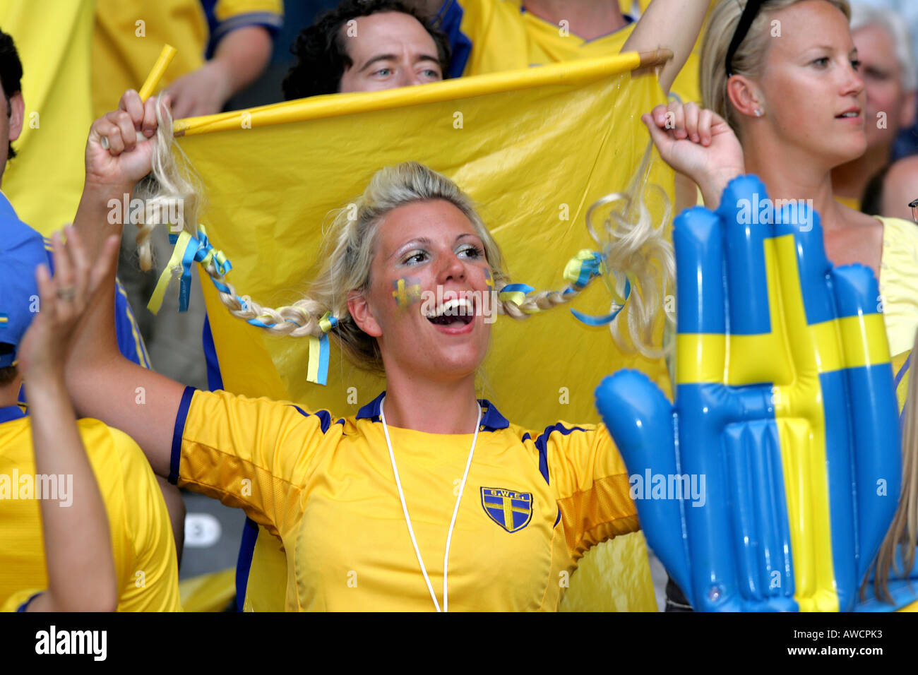 A female Swedish fan singing in the crowd during the 2006 World Cup Stock Photo