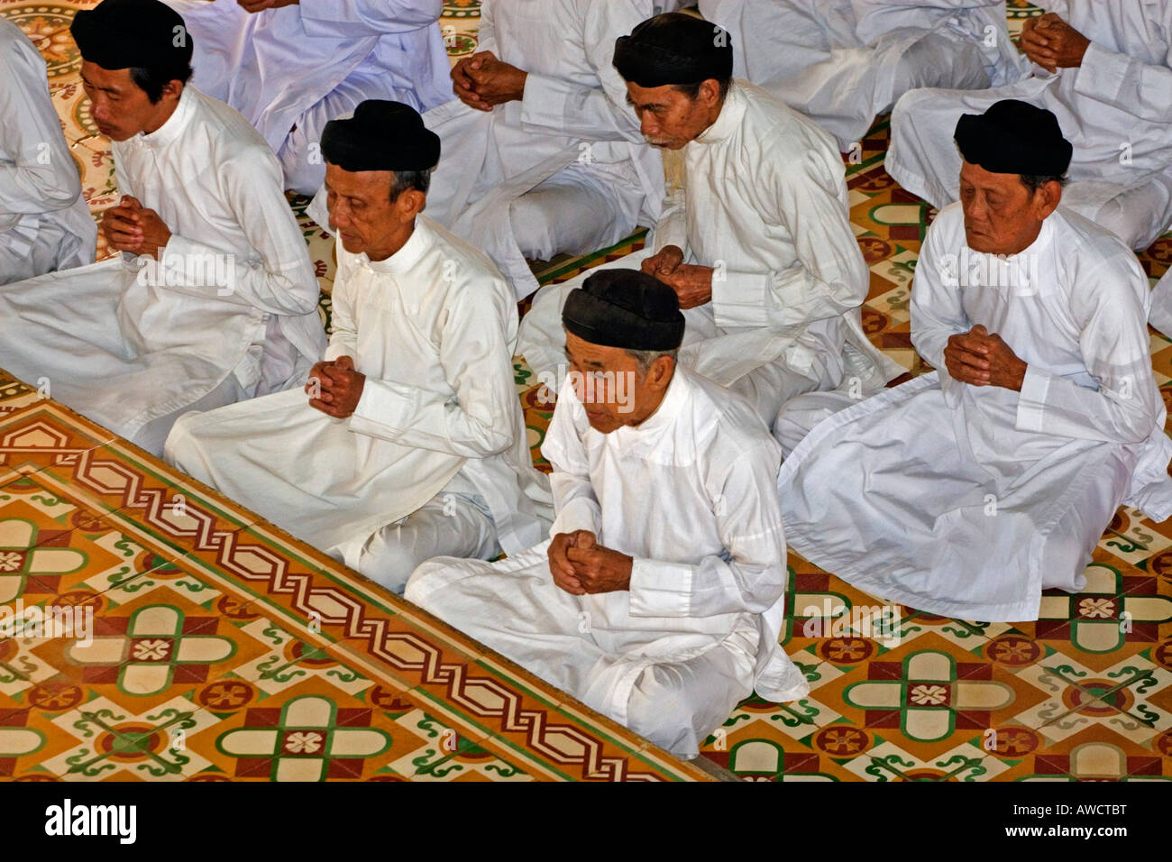 Followers of the Cao Dei religion praying in Tay Ninh, Vietnam, Southeast Asia Stock Photo