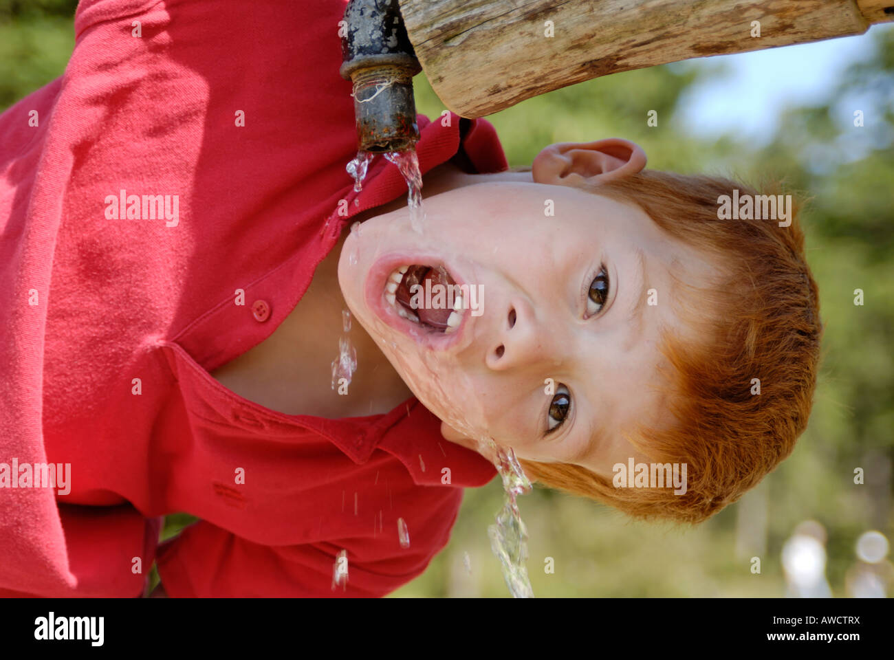 Child drinking natural water from a fountain Stock Photo