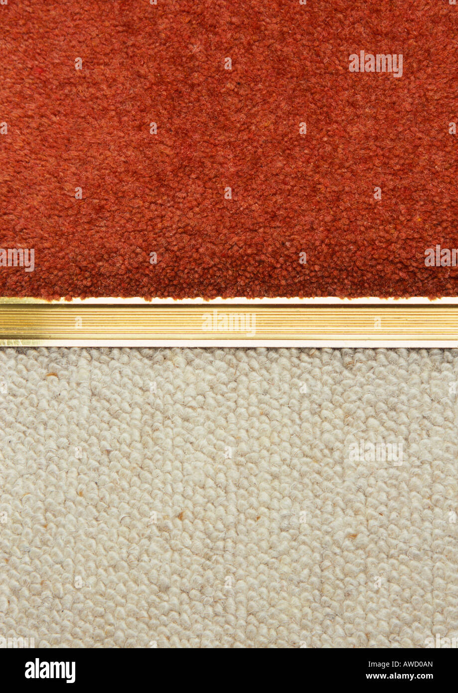Gold aluminium carpet edging door strip between red and cream carpets