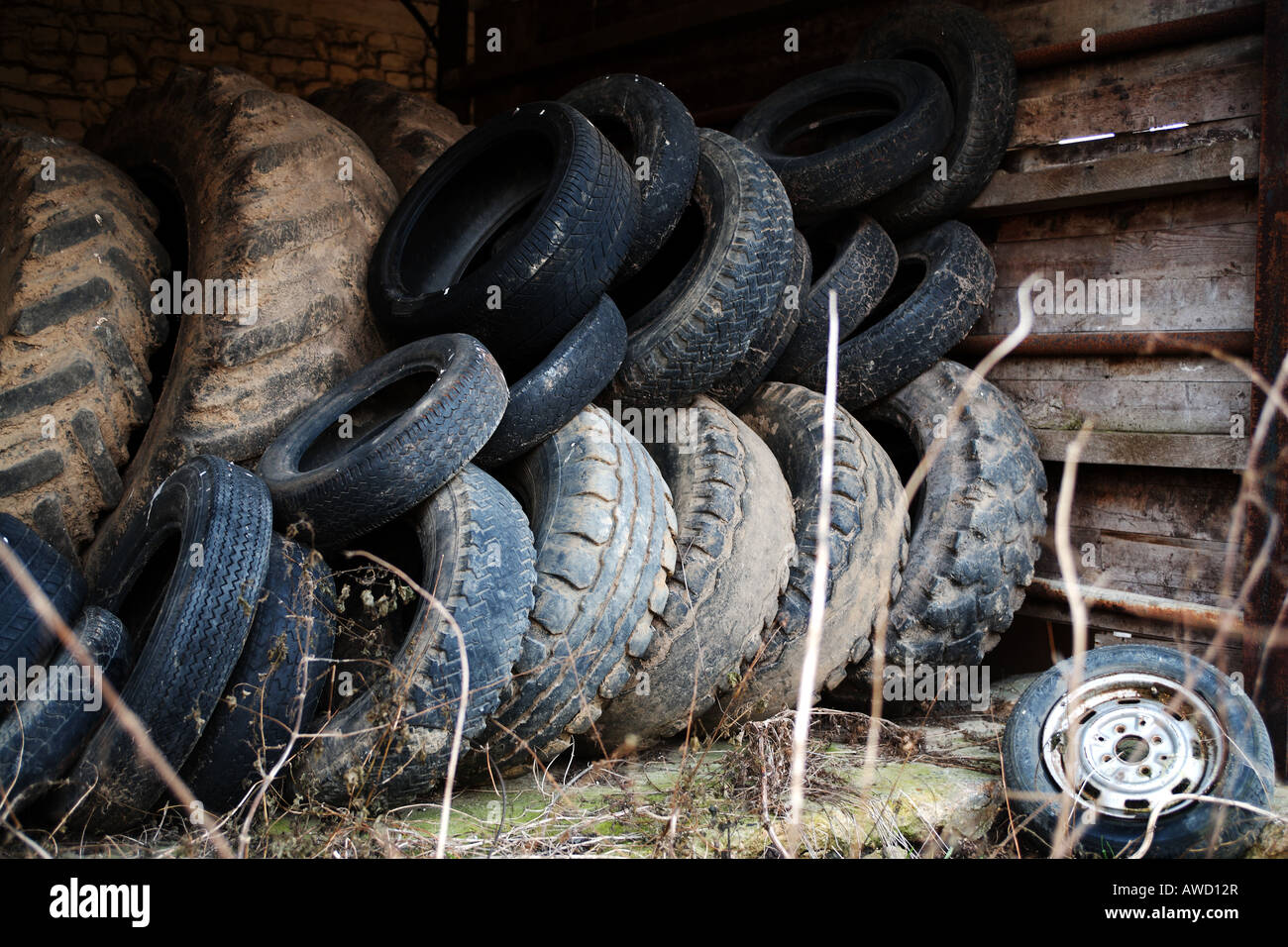 Piles of disused tyres/tires on a farm. Colour Stock Photo