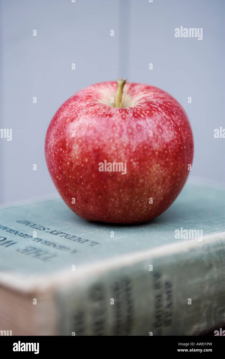 Red apple on an old book Stock Photo