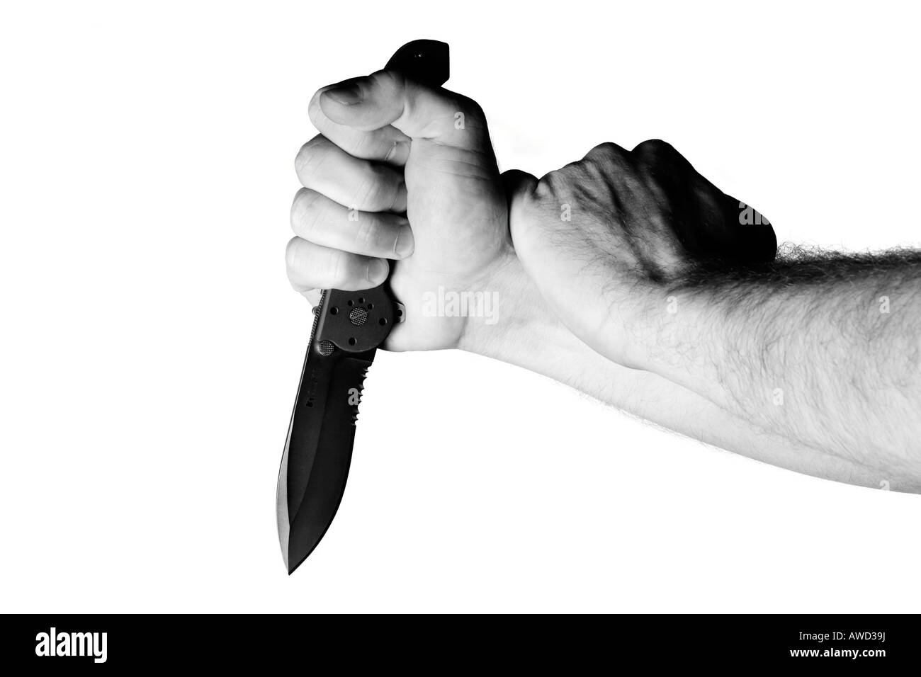 Hand making stabbing motion with jackknife Stock Photo