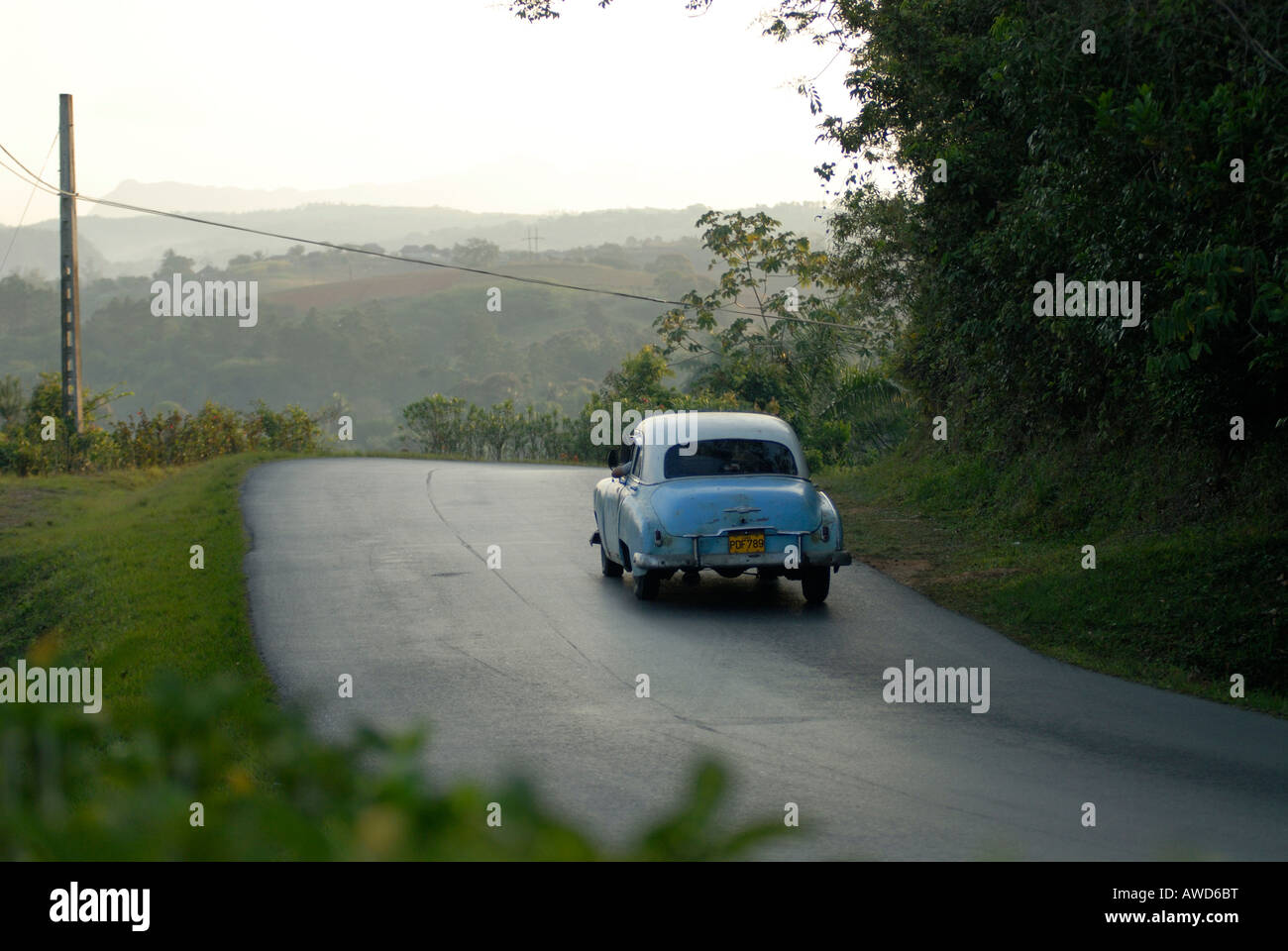 Vintage car driving on the road going from Pinar del Río to Vinales, Cuba, Caribbean, Americas Stock Photo