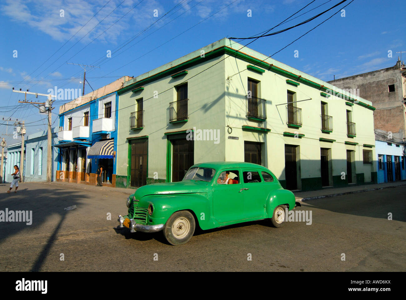 Green vintage car driving on a street in Cienfuegos, Cuba, Caribbean, Americas Stock Photo