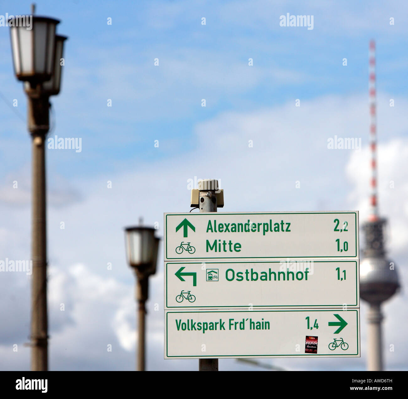 Bicycle tour in heaven - Signs beside old street lanterns and the tv tower show directions to different places in Berlin, Germa Stock Photo