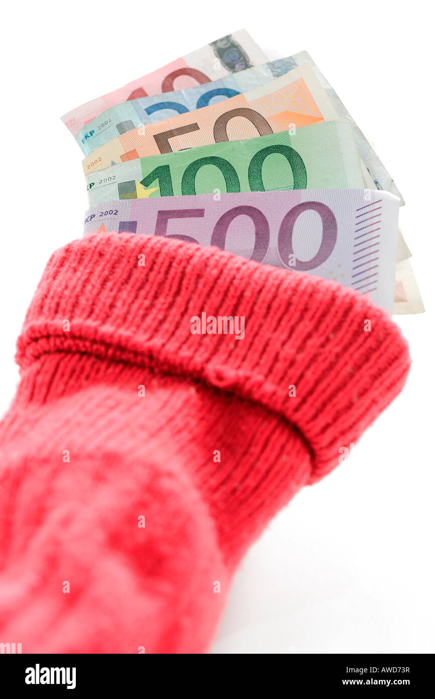 Saving money - Euro bank notes put into a red sock deposit Stock Photo