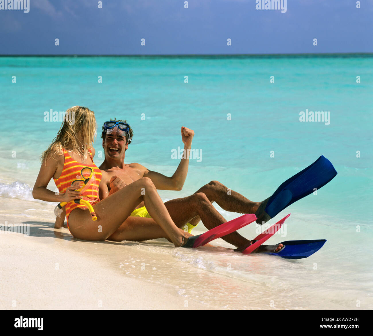 Young couple with snorkeling gear enjoying themselves on a sandy beach, vacation, Maldives, Indian Ocean Stock Photo