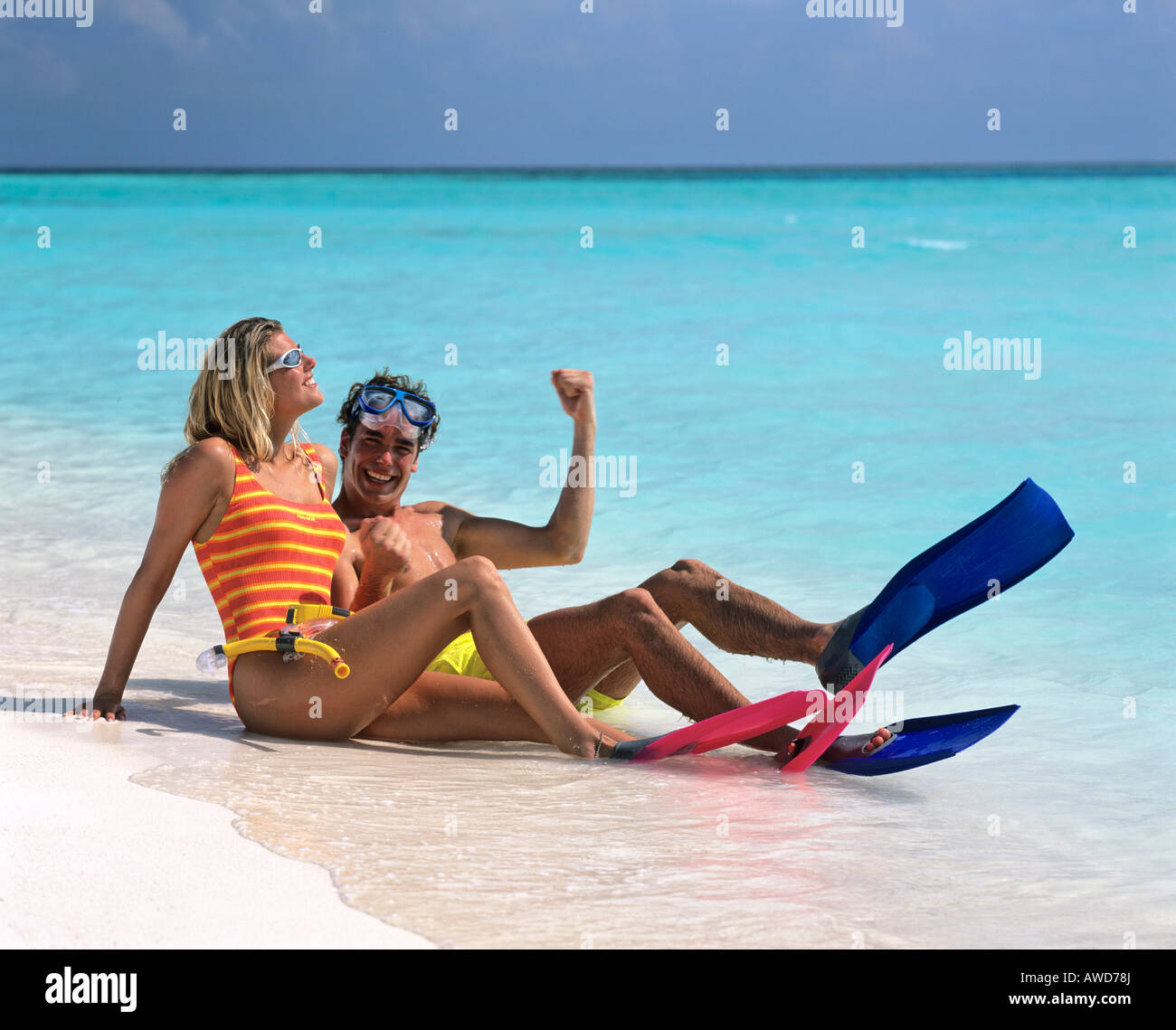 Young couple with snorkeling gear enjoying themselves on a sandy beach, vacation, Maldives, Indian Ocean Stock Photo