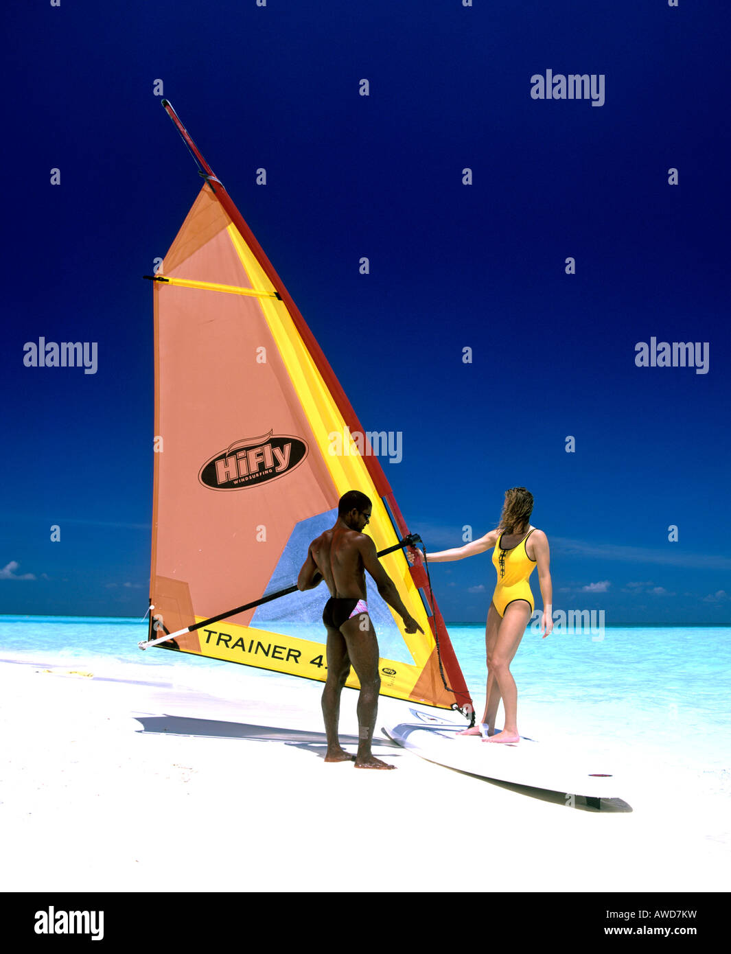 Young woman with a windsurf board, windsurfing lessons, Maldives, Indian Ocean Stock Photo