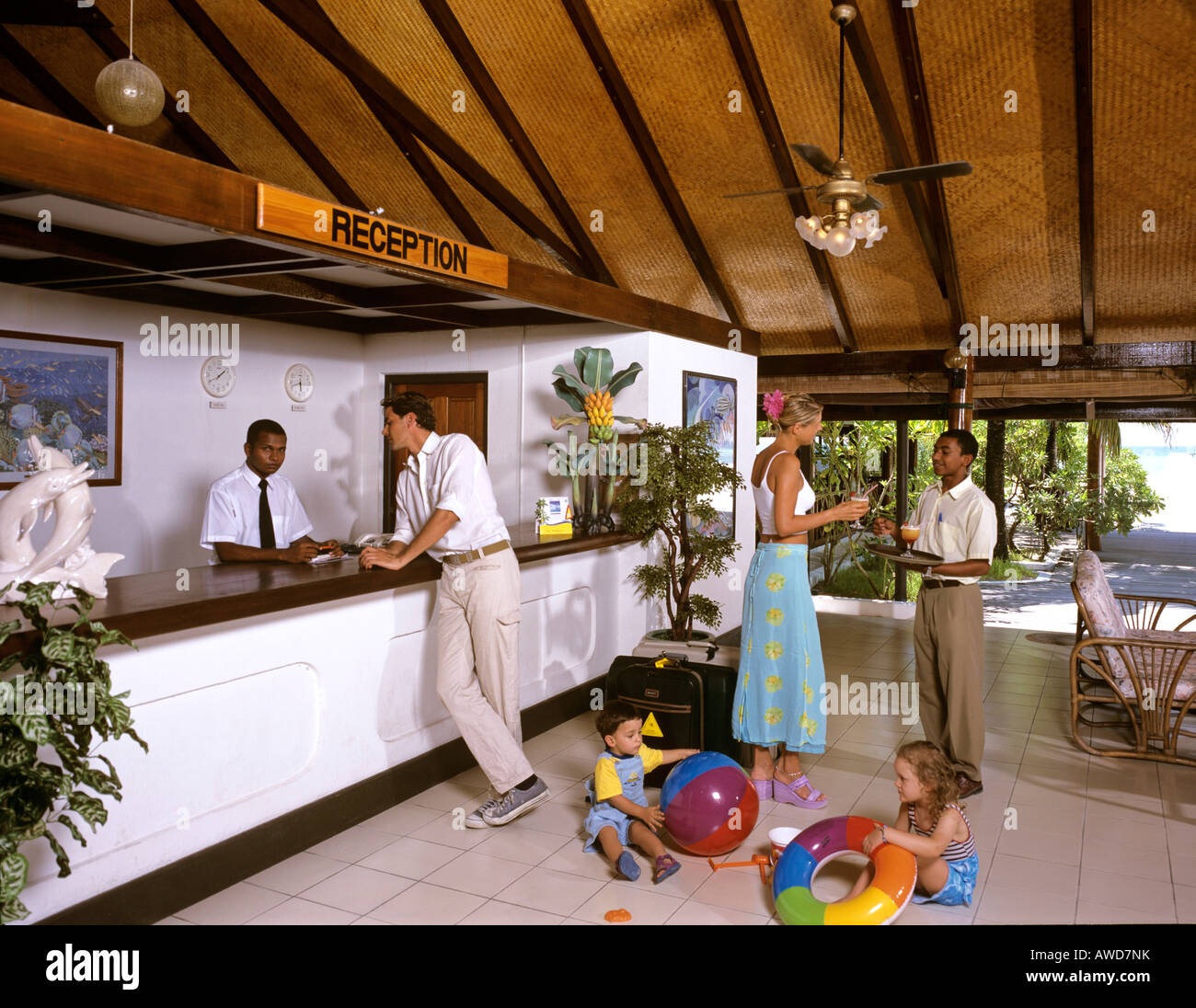 Hotel reception, family checking in, welcome drink, Holiday Island, South Male Atoll, Maldives, Indian Ocean Stock Photo