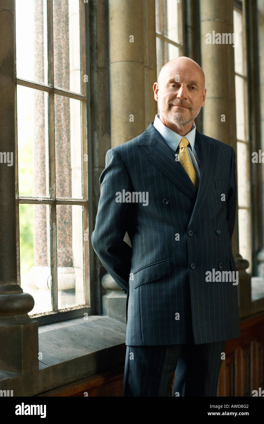 Businessman Standing by Window Stock Photo
