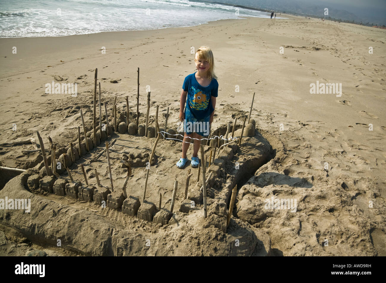 Girl and her sand castle Ventura, Harbor, Beach California, USA Stock Photo