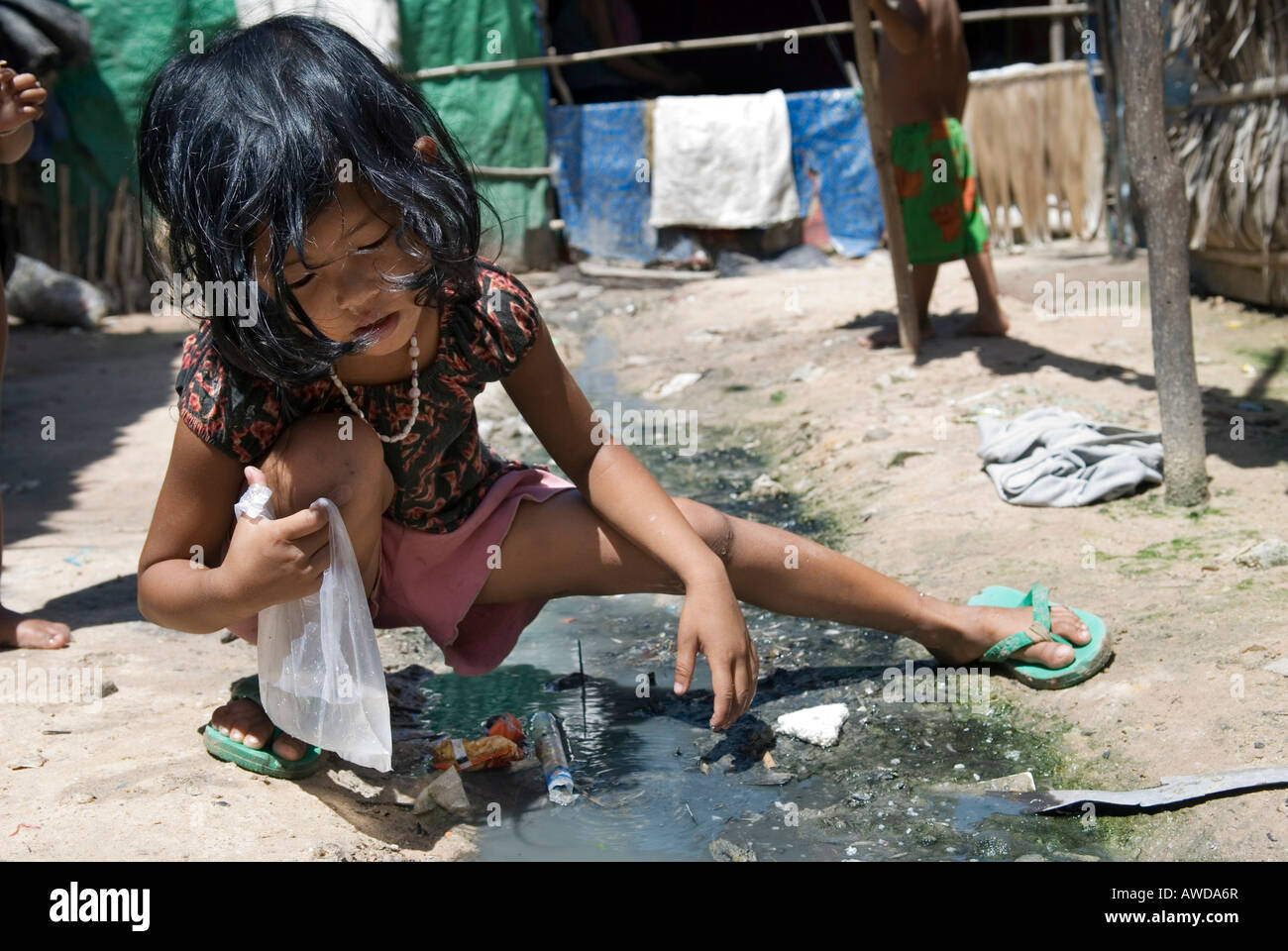 Girl playing in the cloaca, Andong slum area, Phnom Phen, Cambodia Stock  Photo - Alamy