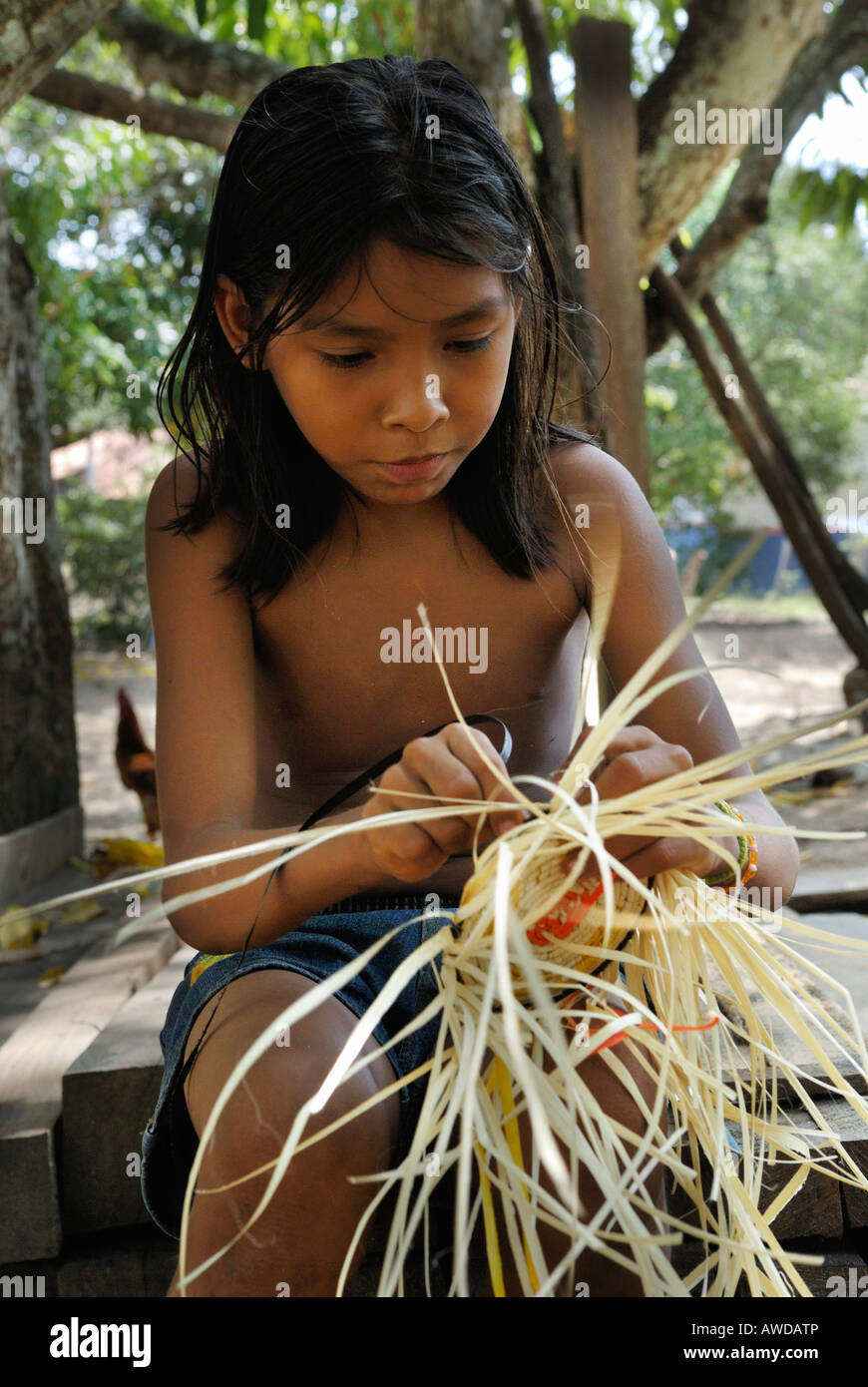 Girl lacing a basket of Tucuma palm fibers (Astrocaryum vulgare), Amazon Basin, Brazil Stock Photo
