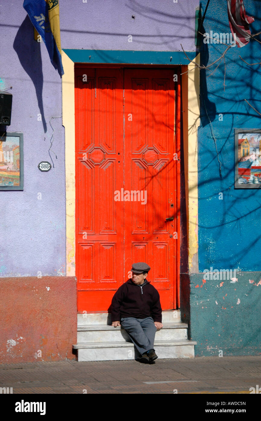 Old man in front of coloured facade, La Boca, Buenos Aires, Argentina Stock Photo