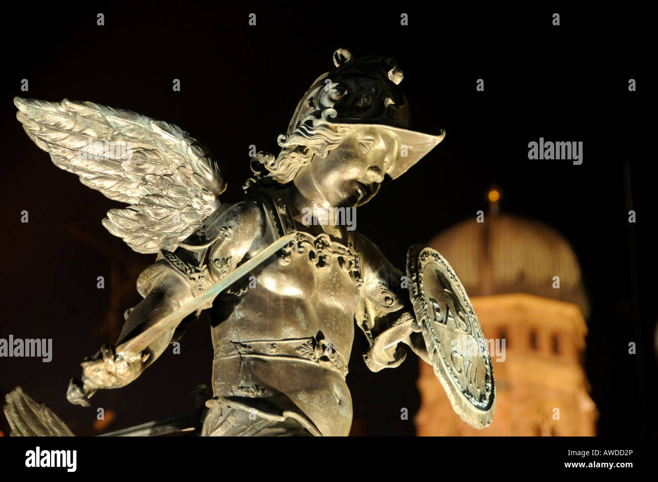 Nighttime shot, angel statue in front of the Mariensaeule (Marian Column) with the towers of the Frauenkirche Church in the bac Stock Photo
