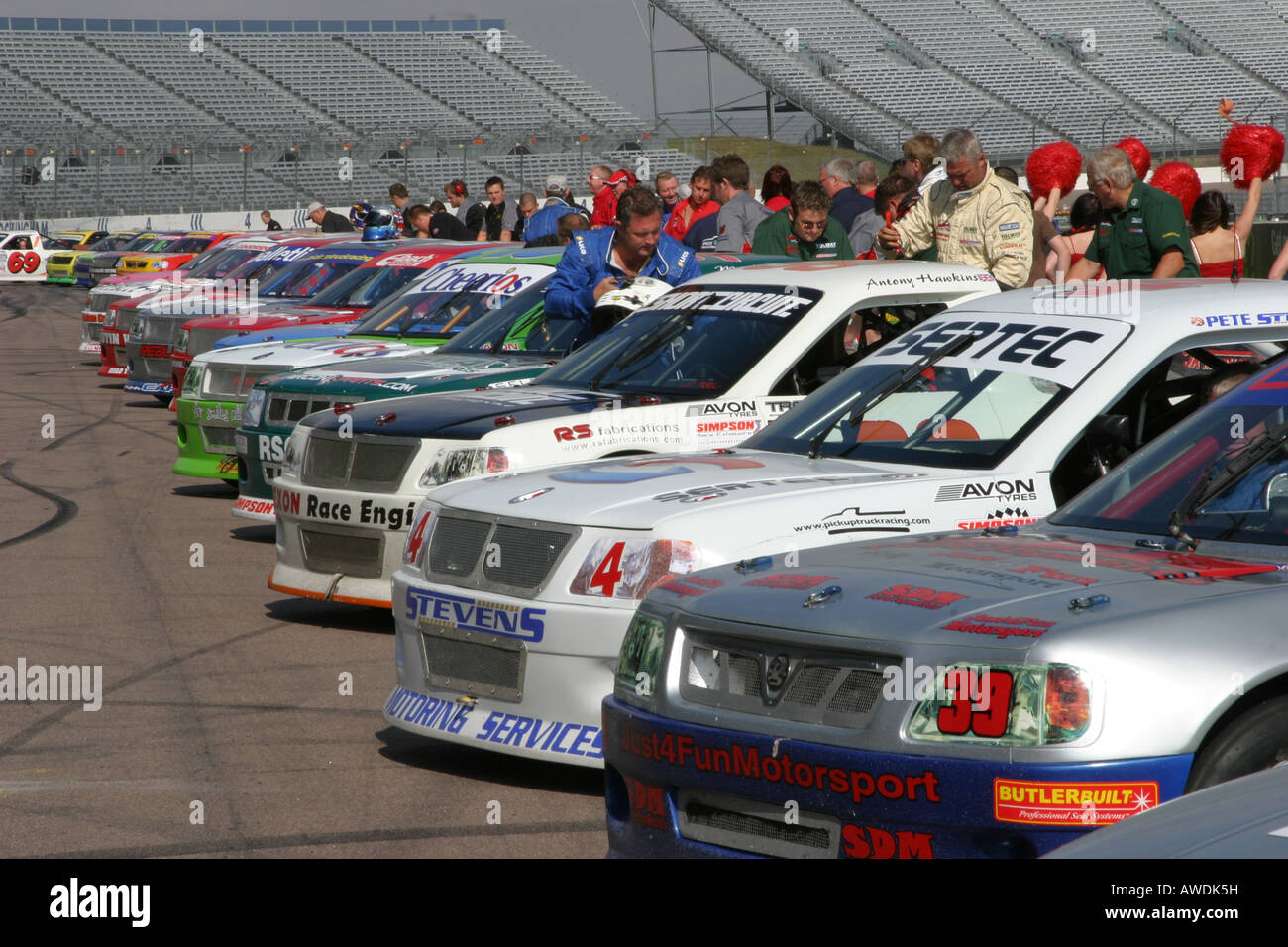 Racing pick up trucks lined up with drivers by trucks Stock Photo - Alamy