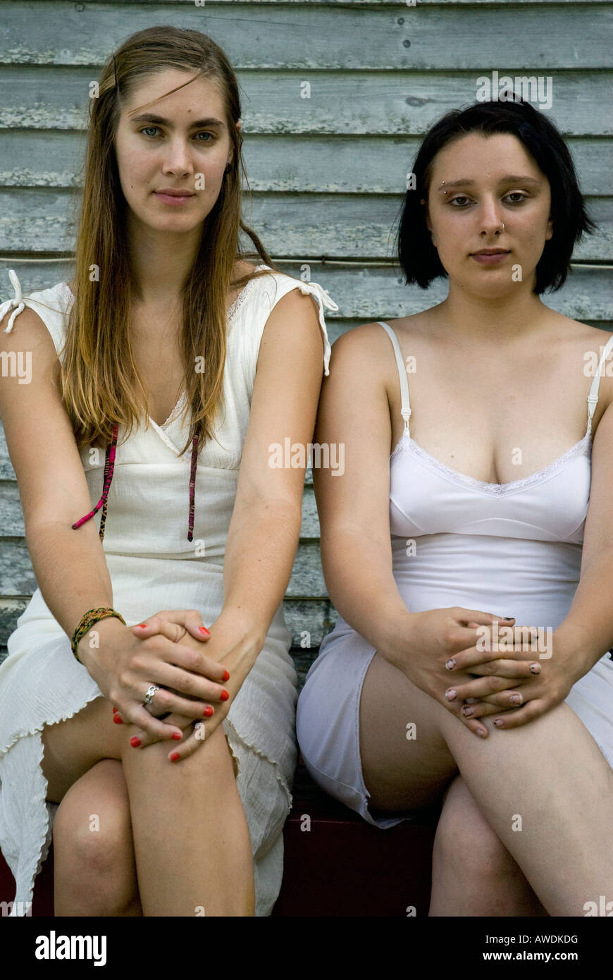 two seated girls with legs crossed wearing vintage slips Stock Photo - Alamy