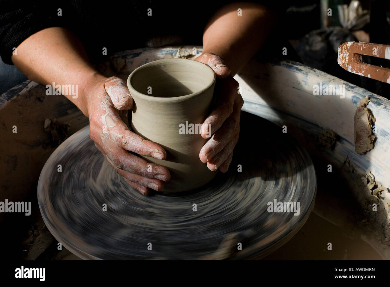 Cornish Potter Deborah Mitchell Sits at her wheel in her pottery in