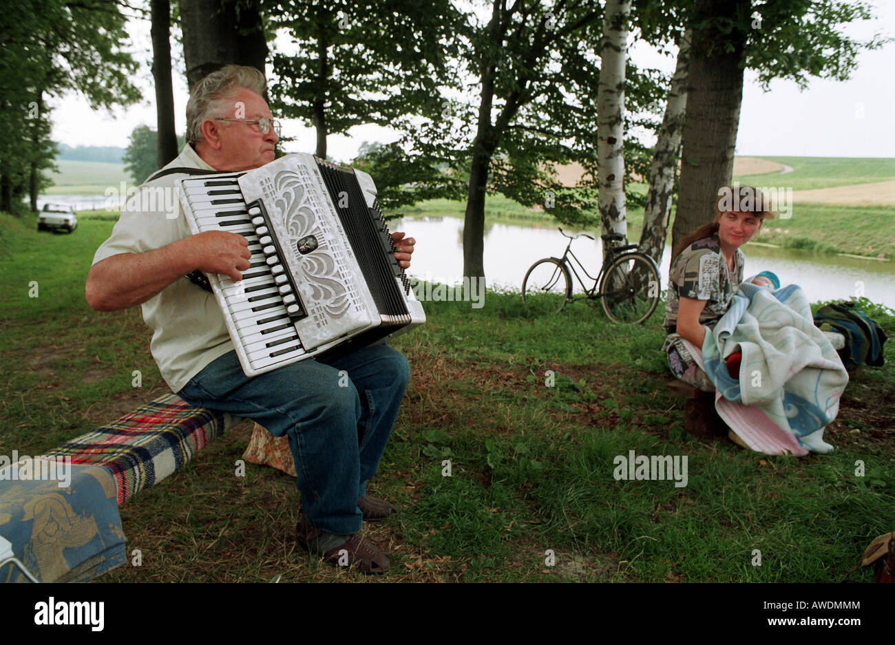Man playing accordion in the countryside, Kotulin, Poland Stock Photo