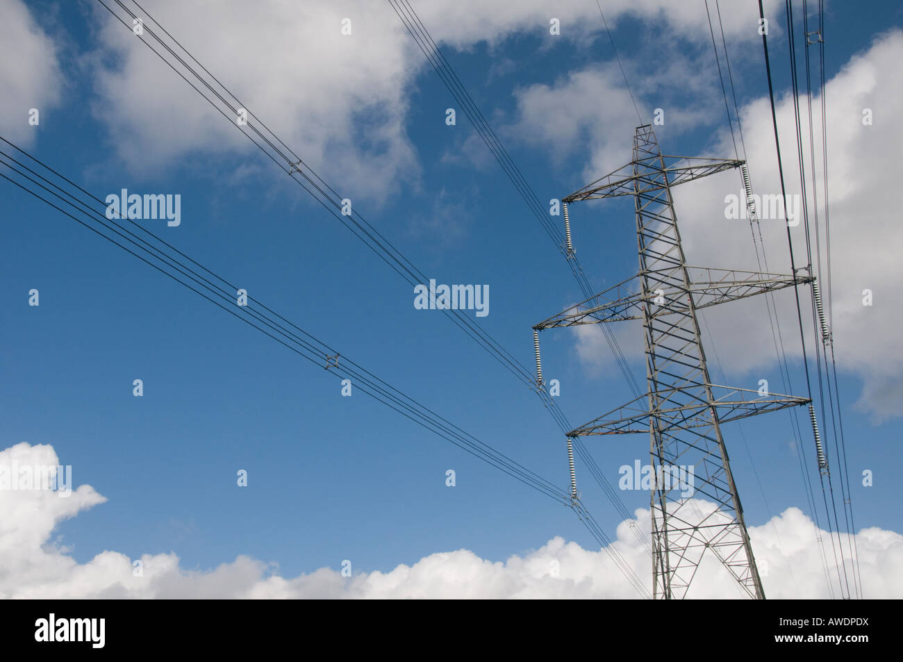 Electricity pylon with white clouds and blue sky Stock Photo - Alamy